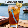 Glass of iced tea with "Vasco Lake" and compass design, lemon slice.