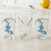 Three clear glasses with blue lake maps and compass rose designs.