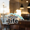 Wheeler Life sticker with turquoise outline on glass