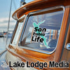 Turquoise San Pablo Life sticker on a wooden boat window with Lake Lodge Media text.