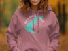 Pink hoodie with a turquoise outline of Mississippi and compass graphic.