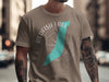 T-shirt graphic: Redfish Lake, Idaho, shape of lake within compass, light brown shirt.