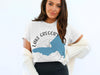 White t-shirt with blue Lake Gregory, California map and compass graphic.