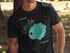 Black t-shirt with "Crater Lake" text and a teal map illustration.