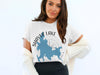 White T-shirt with Shaver Lake California map graphic and compass design.