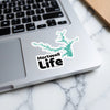 Hartwell Life sticker with lake outline on laptop keyboard.