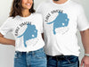 "Lake Simcoe Ontario" text on white t-shirts with blue lake outline and compass graphic.