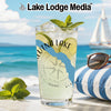 Glass of lemonade with lime and mint, beach scene with sailboat and sunglasses.