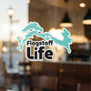 Flagstaff Life sticker with turquoise map outline and copyright text.