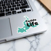 Caddo Life sticker on a laptop keyboard with a marble background.