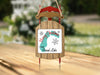 Sled ornament with "Merry Christmas FROM Grand Lake" text and snowflakes.