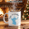 White mug with Lake Pleasant Arizona map and compass design, near a fireplace.