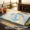 A rectangular glass cutting board with a blue Lake Wappapello map graphic resting on a wooden dock surface.