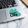 Teal sticker with black text "Hauser Life" on a laptop.