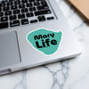 Turquoise sticker with black text "Mary Life" on a laptop keyboard.