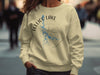 Light yellow sweatshirt with Tellico Lake Tennessee map and compass design.