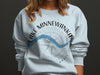 Lake Minnewanka Banff NC graphic on light blue sweatshirt.