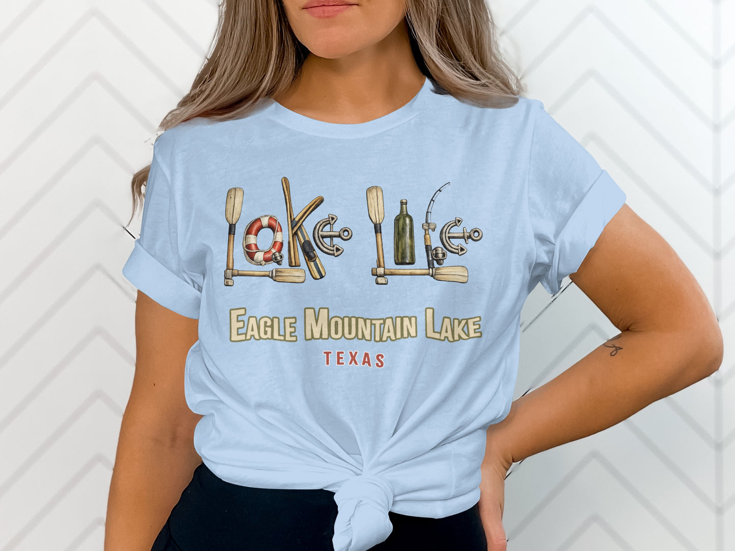 Pale blue t-shirt with Eagle Mountain Lake, Texas graphic and nautical icons.
