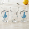 Three clear glasses with Calcasieu Lake map and compass graphic.