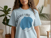 Light blue t-shirt with text "BUFFALO LAKE MINNESOTA" and a blue lake shape.