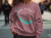 Sanibel Island Florida graphic on a dusty rose sweatshirt with compass and map outline.