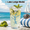 Glass with drink, limes, mint, and Lake Burton logo on beach background.