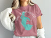 Pink t-shirt with teal outline of Lake Tohopekaliga, Florida and compass rose.