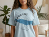Light blue t-shirt with "Oneida Lake" and compass design featuring blue lake outline.