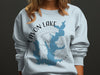 Light blue sweatshirt with "Lavon Lake Texas" and a blue lake outline graphic.