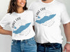 White t-shirts with blue Lake Erie graphic, compass, and text.