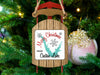 Sled ornament with "Merry Christmas from Castaic Lake" text on a Christmas tree.