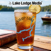 Iced tea in a glass with a lemon slice and a lake map design.