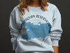 Light blue sweatshirt with "Manasquan Reservoir New Jersey" text and blue map graphic.
