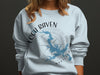 Light blue sweatshirt with Loch Raven Maryland map and compass design.