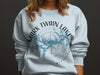 Light blue sweatshirt with Mark Twain Lake Missouri design and compass rose.
