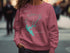 Pink sweatshirt with "Beautiful New Melones Lake California" and compass graphic.