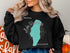 Black sweatshirt with Lake Winnebago, Wisconsin map and compass graphic.
