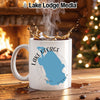 White mug with Lake George Florida map graphic, steaming coffee splashing, fireplace, and Christmas tree.