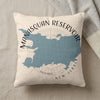 Cream pillow with blue Manasquan Reservoir map and text, resting on a linen surface.