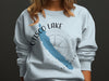 Light blue sweatshirt with Otisco Lake map graphic and compass design.