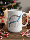 White mug with Lake Ullswater map and compass design, surrounded by Christmas decor.