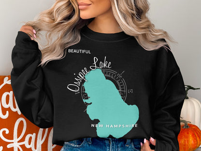 Black sweatshirt featuring a teal map outline of Ossipee Lake, New Hampshire.