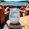 A white wine tumbler with a Grenada Lake Mississippi map graphic sits on a wooden boat table.