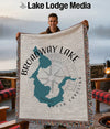 Throw blanket with Broadway Lake outline map and compass design.