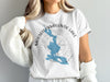 White t-shirt with blue map of Mooselookmeguntic Lake, Maine and compass graphic.