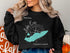 Black sweatshirt with a teal compass rose and "Lake Erie Pennsylvania" text.