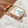 Christmas ornament on a wooden sled with "Merry Christmas FROM Lake Conroe" text.