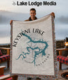 Keystone Lake Oklahoma map woven blanket held by a man outdoors.