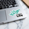 Teal Minnetonka map sticker alongside "Minnetonka Life" text on a laptop.