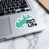 Teal lake silhouette sticker with "Herb Parsons Life" text on a laptop.